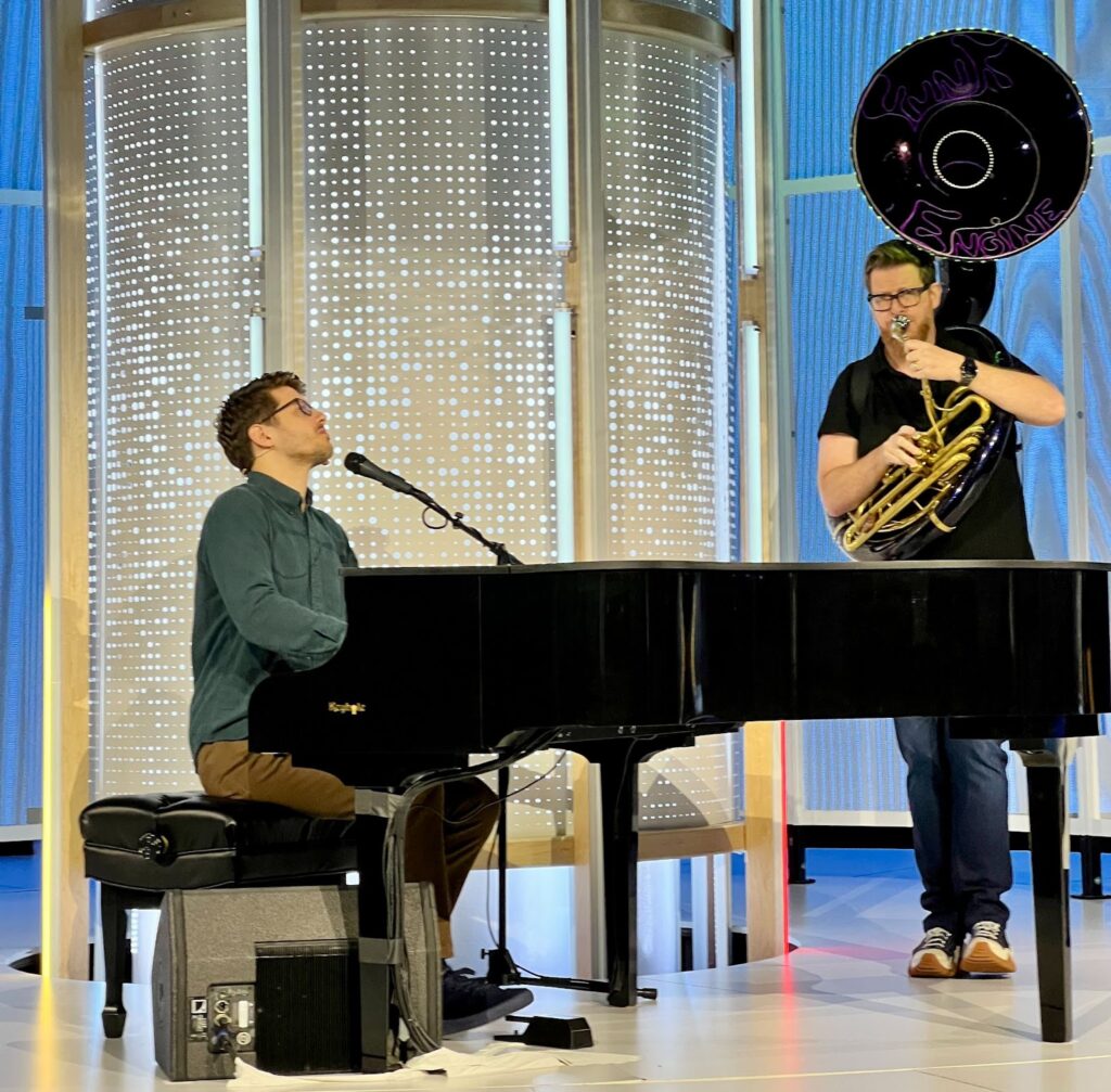 SADA CTO Miles Ward plays tuba at Google Cloud Next 2023 in a duet with Forrest Brazeal, Google Cloud’s Head of Developer Media.